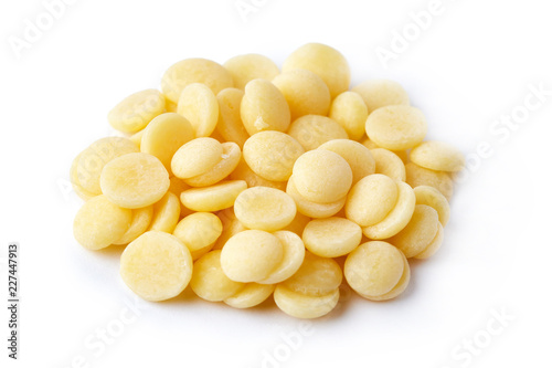 Organic cacao butter buttons (wafers) isolated on white background