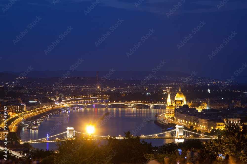 travel and european tourism concept. Budapest, Hungary. Hungarian Parliament Building over Danube River and Szechenyi chain bridge illuminated at night.
