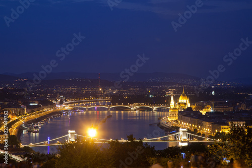 travel and european tourism concept. Budapest, Hungary. Hungarian Parliament Building over Danube River and Szechenyi chain bridge illuminated at night.
