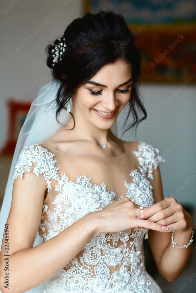 picture of bride looking at wedding ring. Authentic lifestyle image