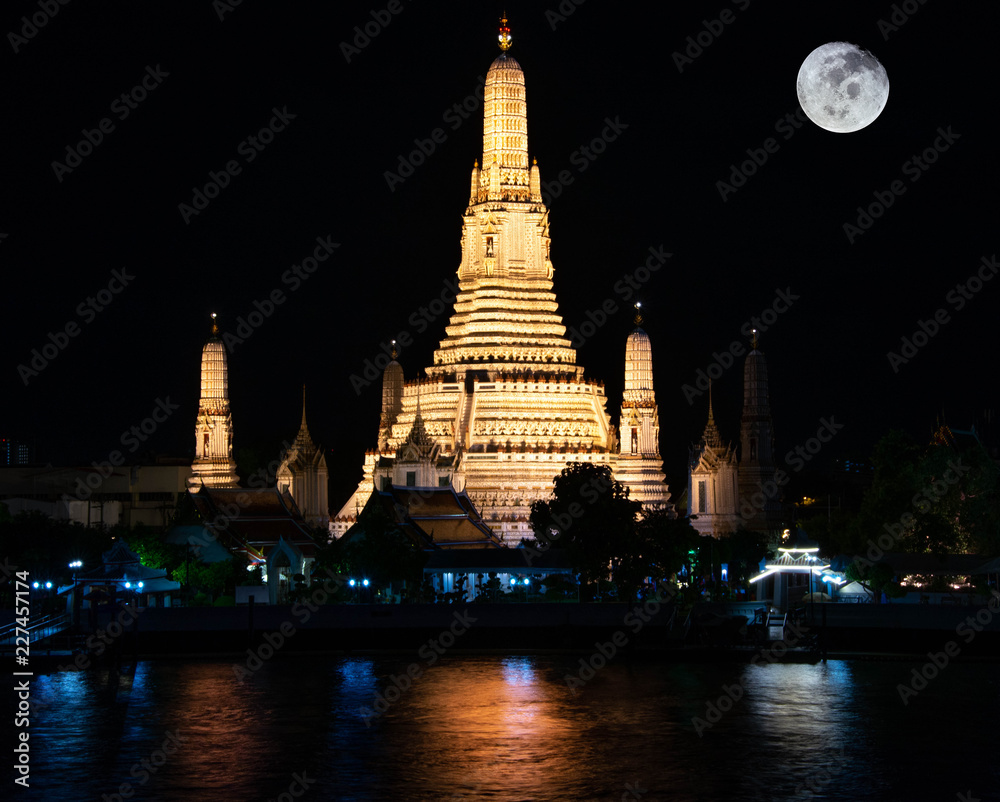 Wat Arun Buddhist Temple in Bangkok at night with moon Wat Arun Buddhist Temple in Bangkok at night with moon