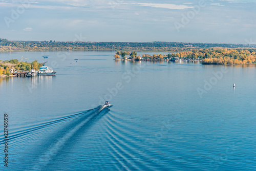 Speedboat floats on the bay - a beautiful sea or river landscape