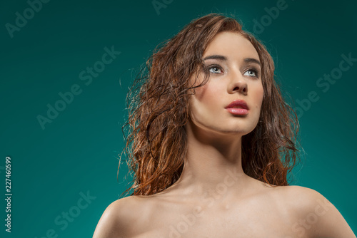pretty girl with natural hair-style on green