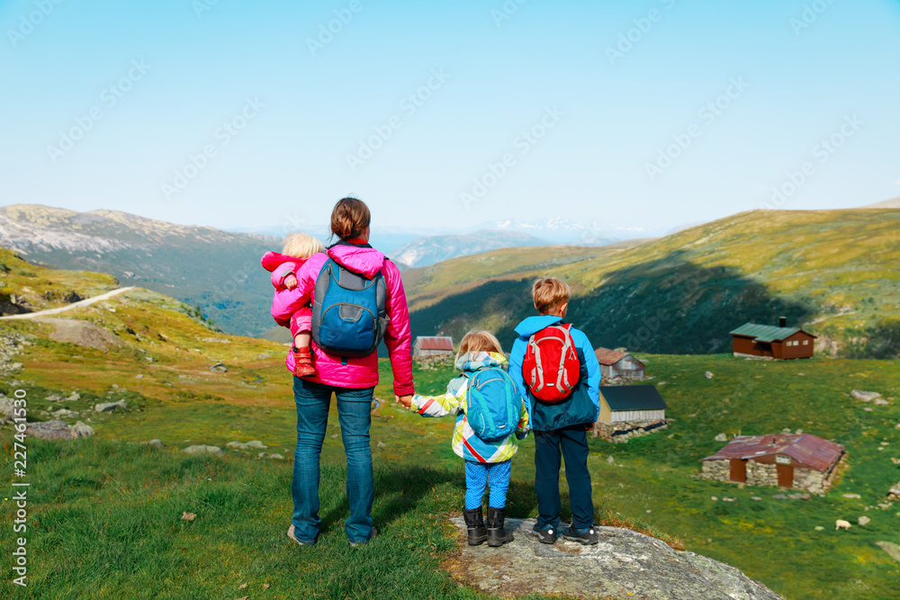 mother with kids travel hiking in nature