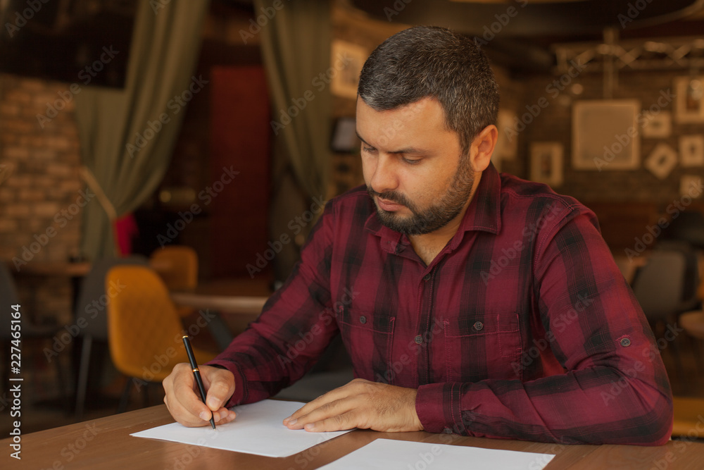 Handsome businessman writing a letter Handsome businessman writing a letter