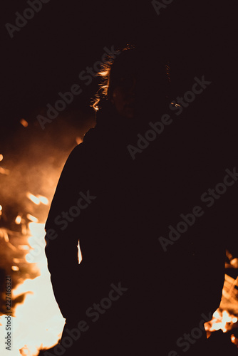 Silhouette illuminated by Camp Fire photo