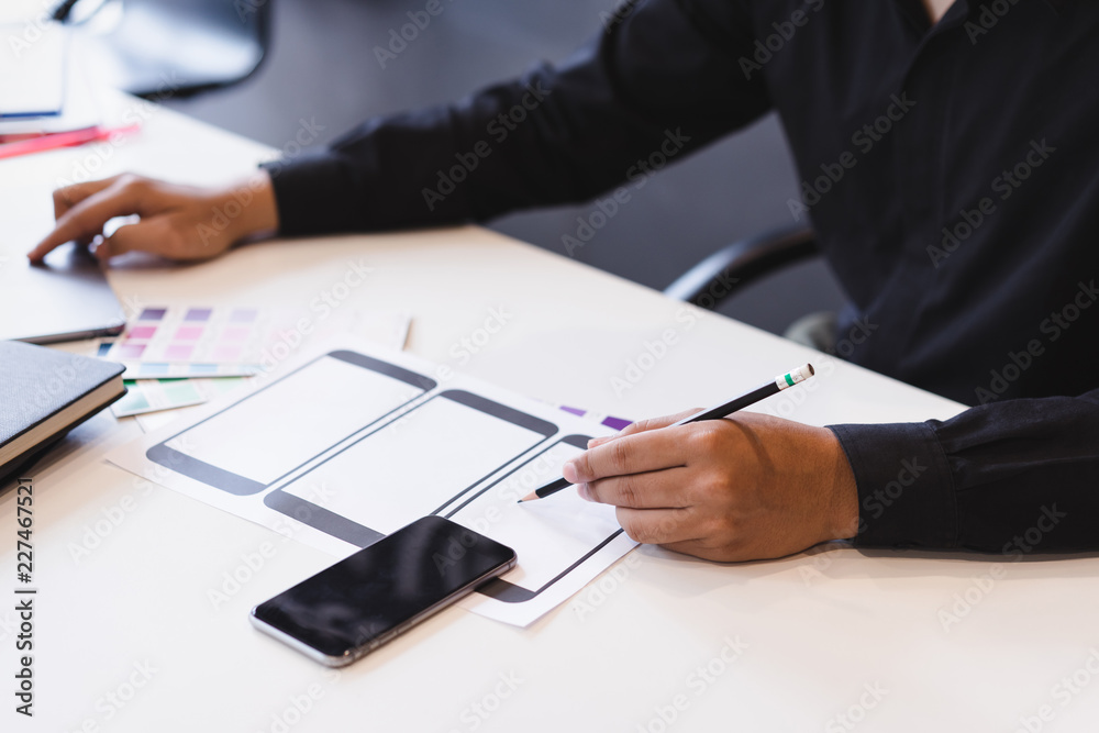 Creative ux designer hands sketching of screens for mobile responsive website development with UI/UX. Creative ux designer hands sketching of screens for mobile responsive website development with UI/UX.