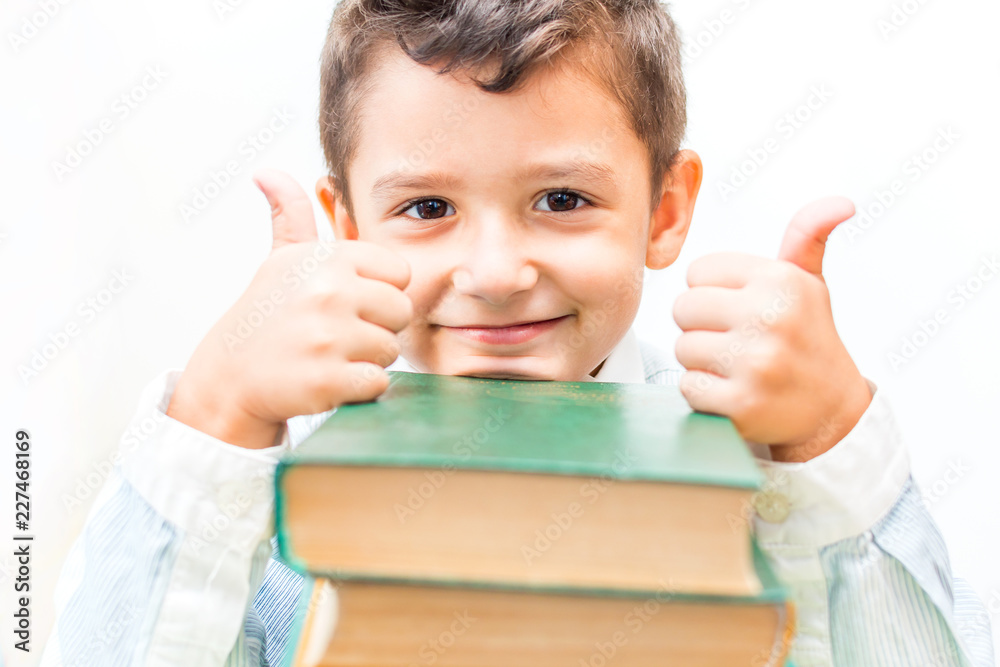 emotional boy with books at the table