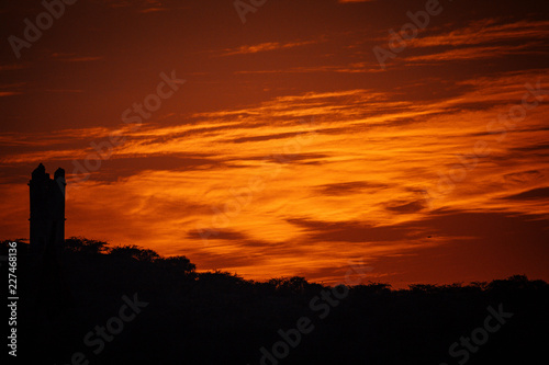 Silhouette of ancient building against sunset