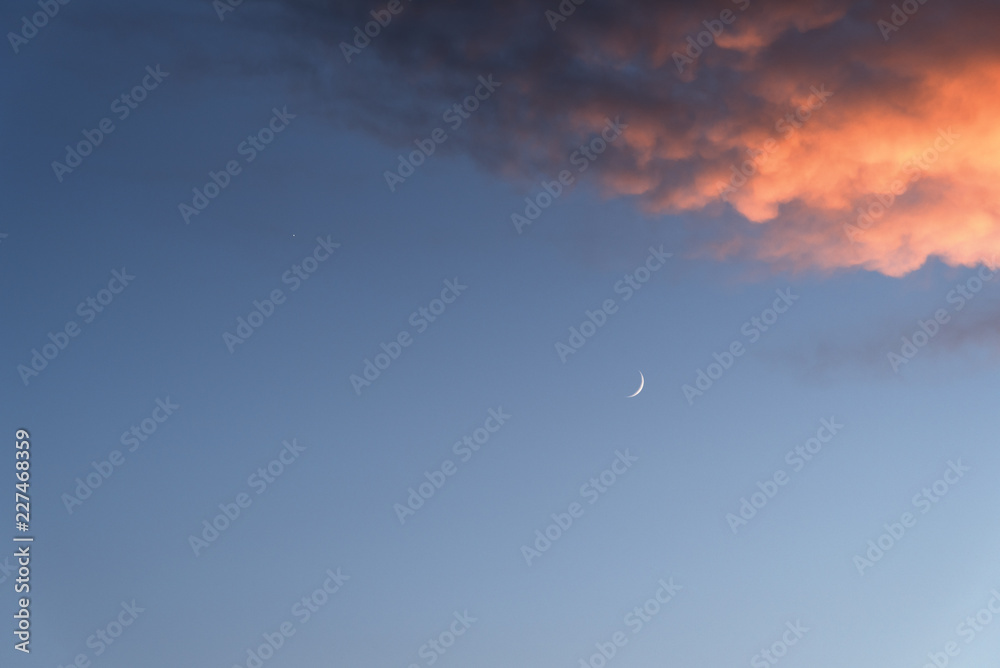 Sunset sky. Moon and clouds