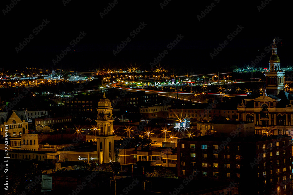 Night aerial view of historic buildings courthouse towers and highway lights