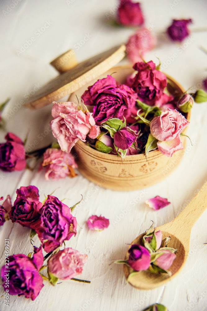 pink buds in a glass jar on a white background pink buds in a glass jar on a white background