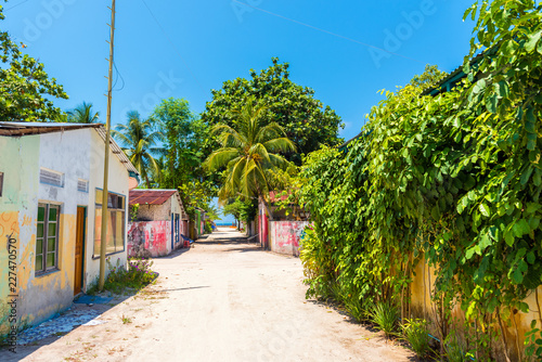 One of the central streets of small tropical island Hangnaameedhoo, overlooking the Indies ocean, Maledives. Copy space for text.