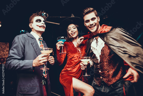 Young Happy People in Costumes at Halloween Party