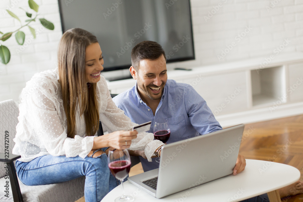 Cheerfull couple looking at laptop in the room Cheerfull couple looking at laptop in the room