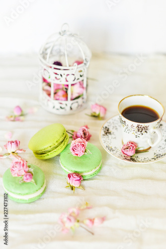 Dessert With Coffee: A Delicate Fresh French Macaroons In Pastel Colors Gift Box Flowers Roses On Light Blue Wooden Background