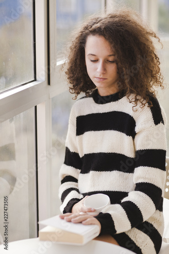 Curly hair teen girl driks ...