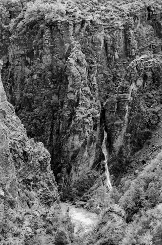 Waterfall in Gorges de Daluis (or "Chocolate canyon" as it called by locals because rocks color) formed by Var river in Provence-Alpes-Cote d'Azur region of France. Black and white photo.