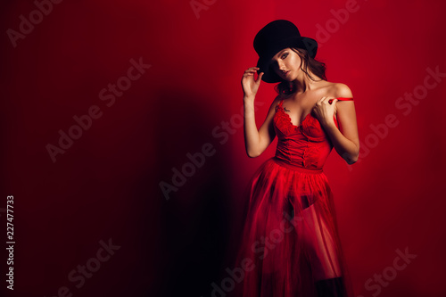 beautiful woman portrait in red dress and a hat