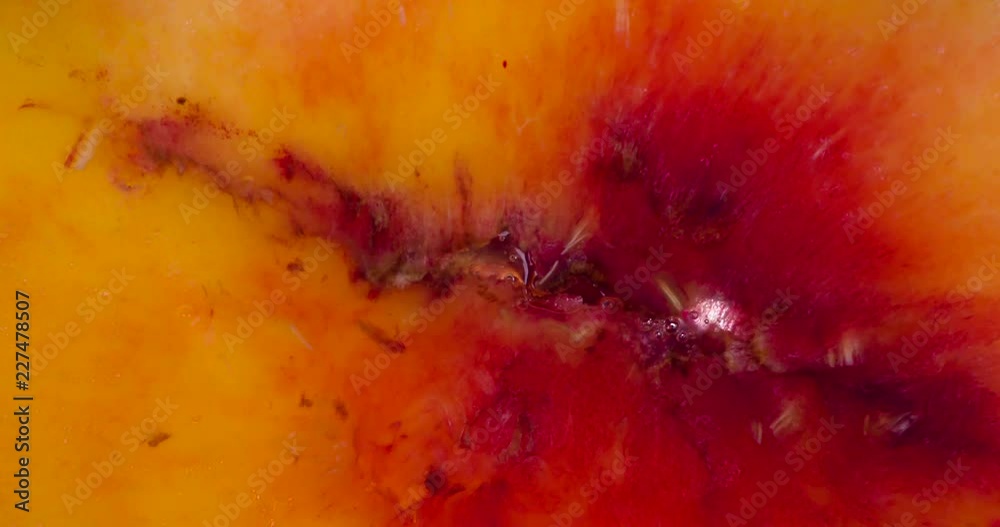 Crush Pulp Ripe Peach. Slices of fragrant ripe Peach are compressed and crushed close-up on a bright white background, creating a juicy stream of Pulp and shell. Shooting at 120fps