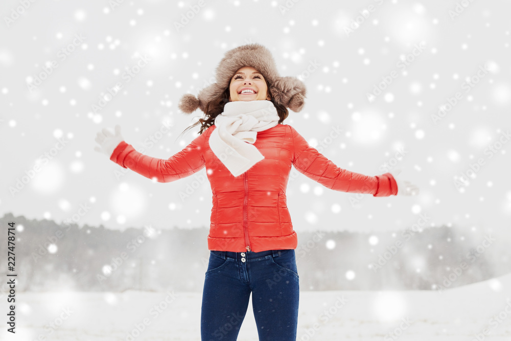 people, season and leisure concept - happy woman in winter fur hat having fun outdoors people, season and leisure concept - happy woman in winter fur hat having fun outdoors