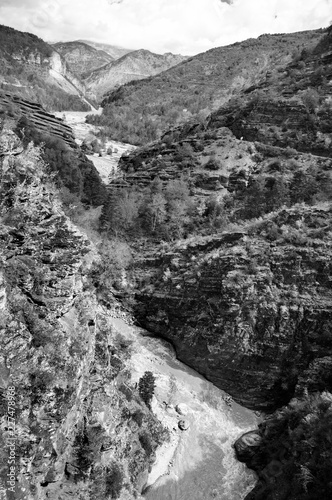 Stream in Gorges de Daluis (or "Chocolate canyon" as it called by locals because rocks color) formed by Var river in Provence-Alpes-Cote d'Azur region of France. Black and white photo.