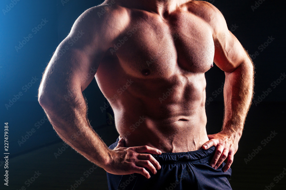 Muscular torso of sexy young fitness male bodybuilder model power athletic man antique statue