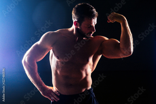 Muscular fitness man antique statue perfect muscles six pack abs and sexy bare nude chest bodybuilder Apollo model posing black background in the studio. competition functional training workout gym