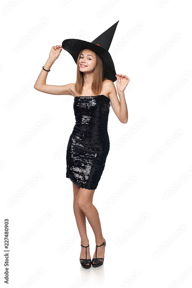 Full length playful Halloween witch isolated on white background Full length playful Halloween witch isolated on white background