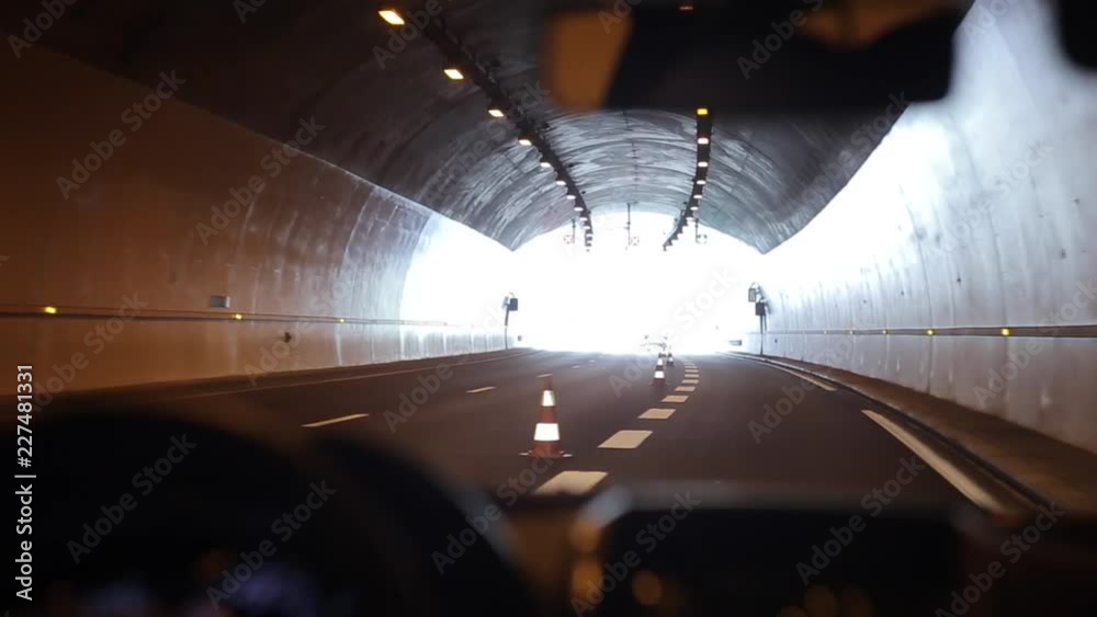 Driving slowly through a tunnel. Light at the end of the tunnel