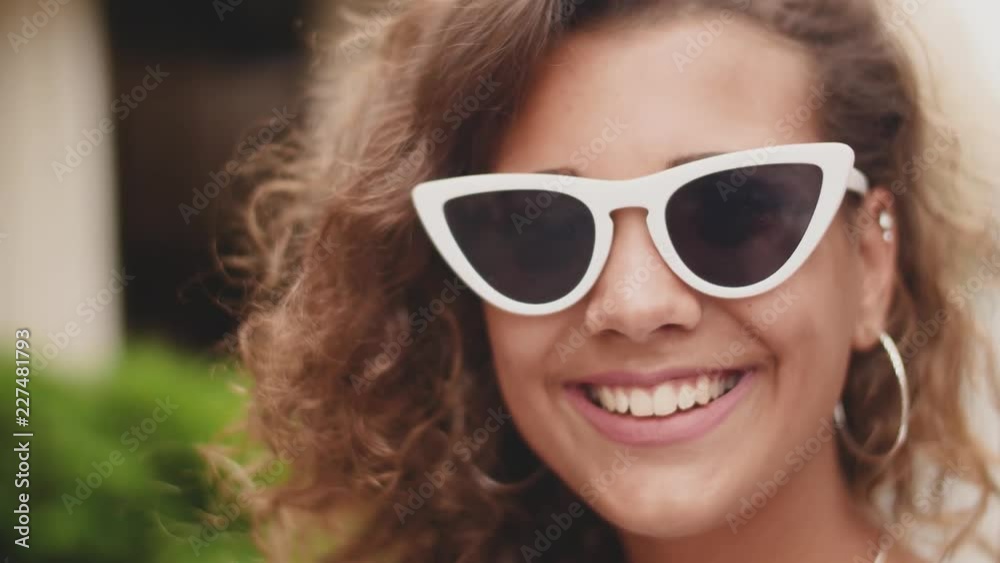 Stylish Woman Wearing Sunglasses Standing On City Street. Close up Stylish Woman Wearing Sunglasses Standing On City Street. Close up