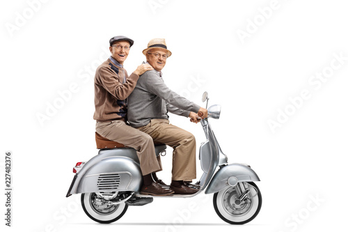 Two senior men riding on a vintage scooter