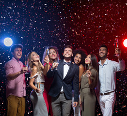 Happy diverse friends celebrating New Year together