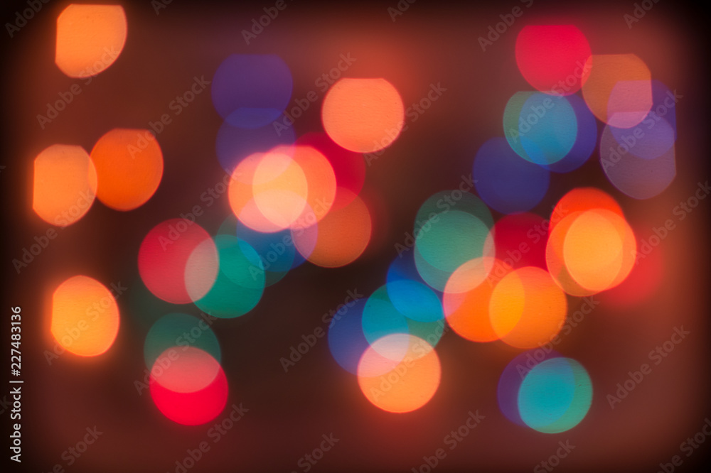 Defocused Christmas garland lights. Background with abstract and colorful bokeh. New Year and holidays concept Defocused Christmas garland lights. Background with abstract and colorful bokeh. New Year and holidays concept