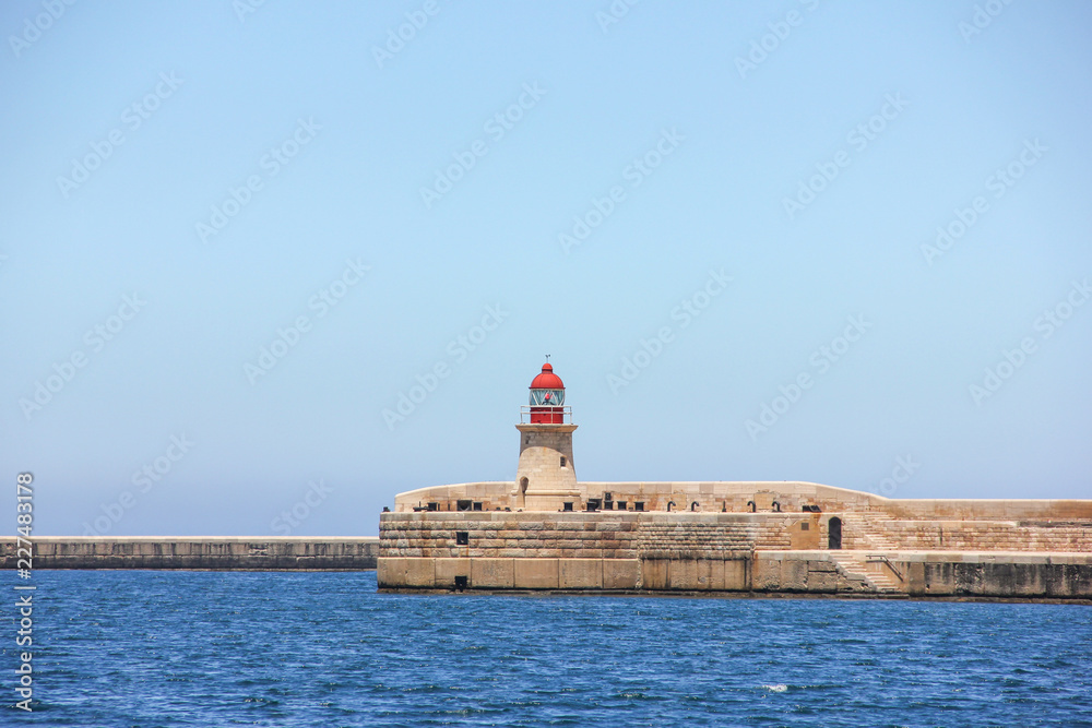 Red lighthouse in Valletta Grand Harbor