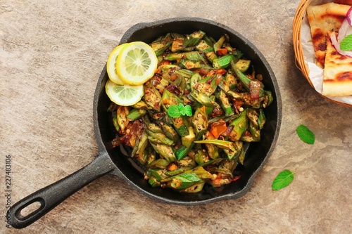 Homemade Bhindi Masala / Okra fry served with Roti, overhead view photo