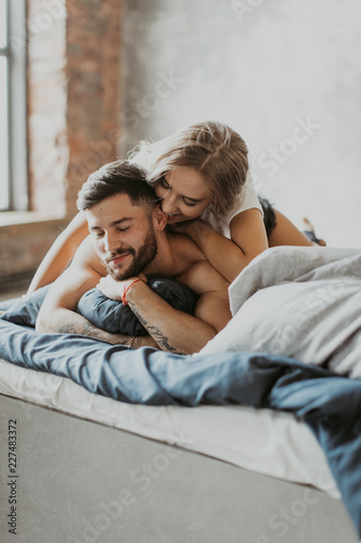  beautiful loving couple kissing in bed