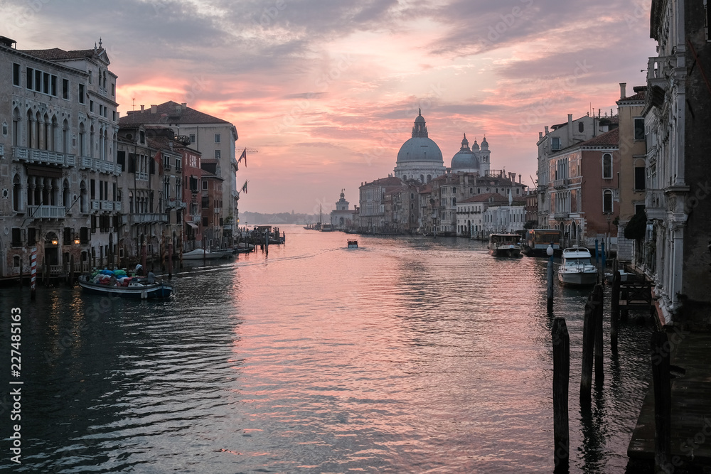 Venice, Italy, September 16, 2018 - Boats on the Grand Canal at sunrise