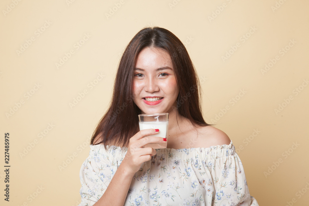 Healthy Asian woman drinking a glass of milk. Healthy Asian woman drinking a glass of milk.