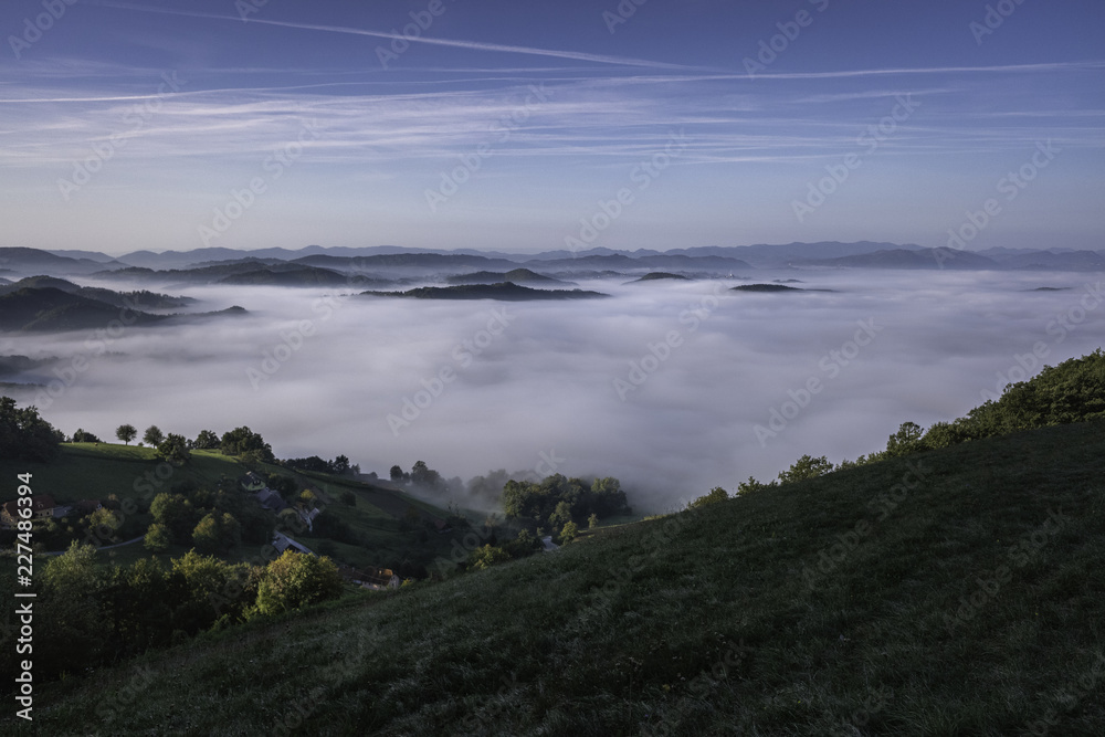 Panoramic foggy landscape in Styria in autumn morning, Slovenia
