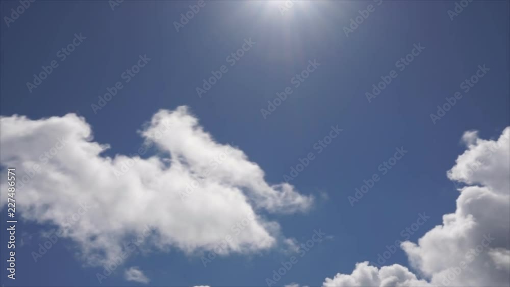 clip of white fluffy clouds over blue sky . clip of white fluffy clouds over blue sky .