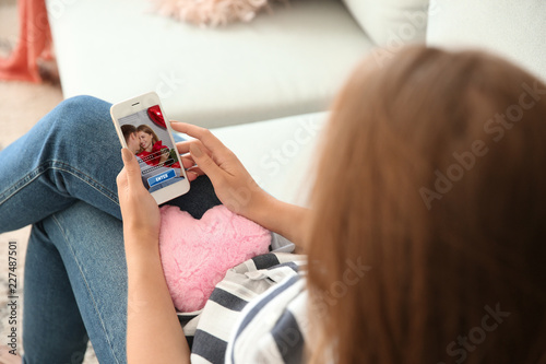 Young woman with mobile pho...