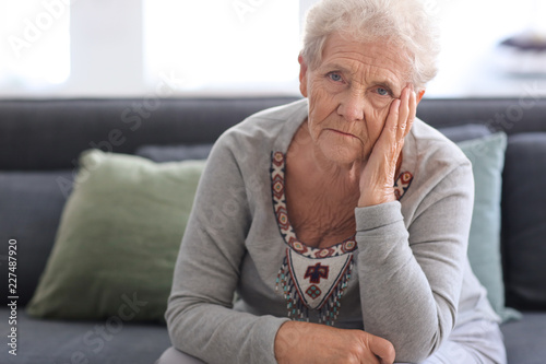 Depressed elderly woman at home