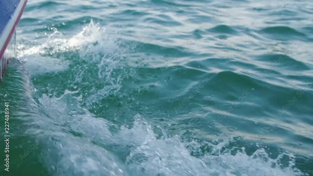 Boat on water causing waves and ripples. Slow motion footage. Boat on water causing waves and ripples. Slow motion footage.