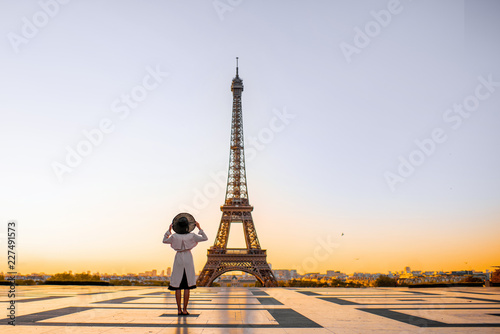Famous square with great view on the Eiffel tower and woman standing back enjoying the view in Paris