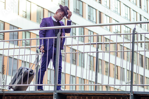 Wallpaper Mural Full body portrait of handsome traveler man African american well dressed stylish businessman walking with suitcase leaving the airport arrival home after business meeting Torontodigital.ca