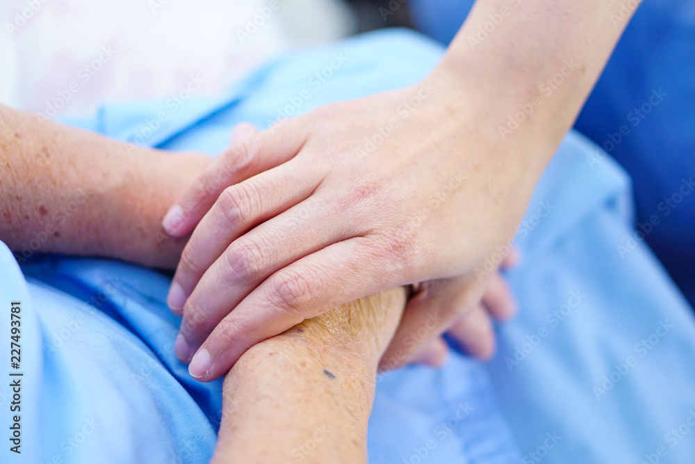 Touching hands Asian senior or elderly old lady woman patient with love, care, helping, encourage and empathy at nursing hospital ward : healthy strong medical concept Touching hands Asian senior or elderly old lady woman patient with love, care, helping, encourage and empathy at nursing hospital ward : healthy strong medical concept