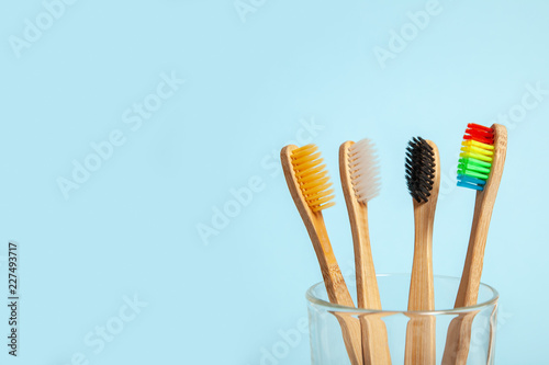 Set of toothbrushes in glass on blue background. Concept toothbrush selection  bamboo eco-friendly. Concept of sexual minorities and LGBT community