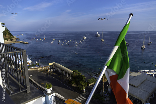View from the balcony to the beach of Capri with the Italian flag