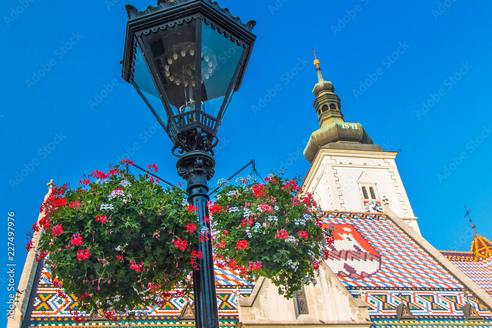 Zagreb, Croatia, church of St. Mark and flowers jardiniere. Upper town, Gornji Grad, historical part of old Zagreb 